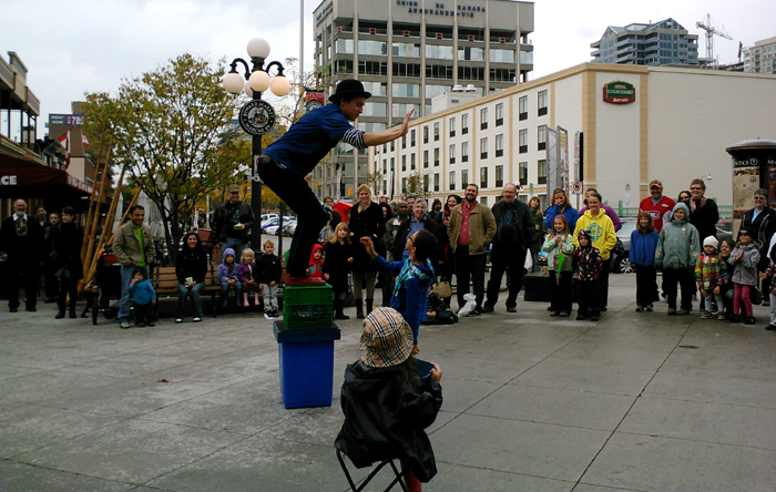Juggling Joe gives volunteer a high 5.
