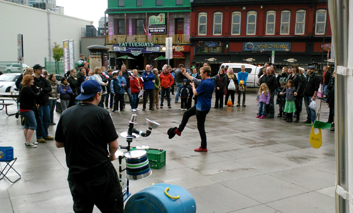 Juggling Joe prepares to catch his hat on his head.