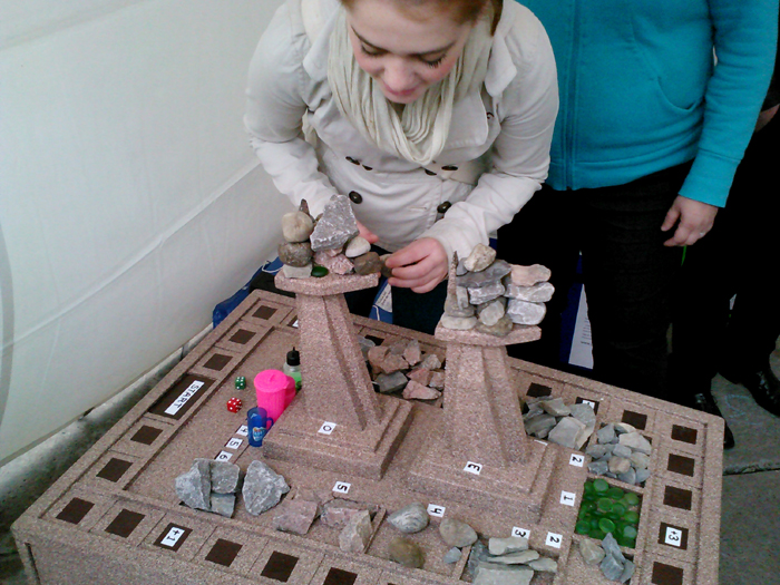A young woman plays Rockt Towers.